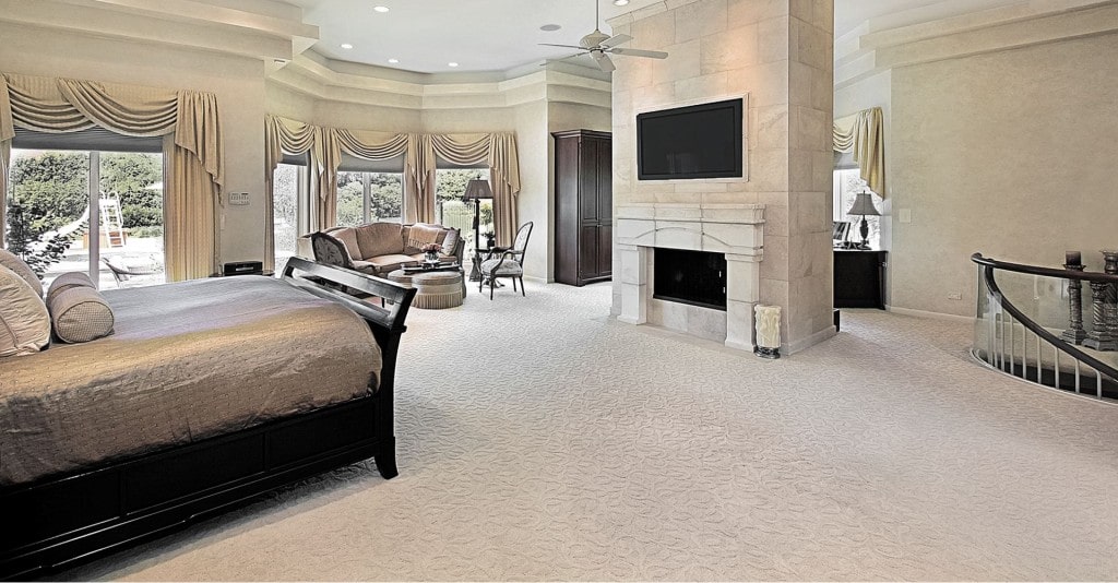 Master bedroom in luxury home with fireplace